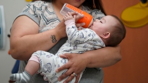 FILE - Elizabeth Amador bottle feeds her daughter Destinee, 9 months, at the Ellis R. Shipp Public Health Centre Thursday, May 12, 2022, in West Valley City, Utah. (AP Photo/Rick Bowmer)