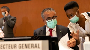 Tedros Adhanom Ghebreyesus, left, Director General of the World Health Organization (WHO), talks with a member of staff during the first day of the 75th World Health Assembly at the European headquarters of the United Nations in Geneva, Switzerland, Sunday, May 22, 2022. (Salvatore Di Nolfi/Keystone via AP)