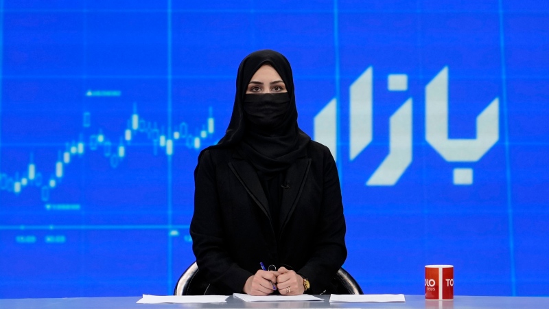 TV anchor Khatereh Ahmadi wears a face covering as she reads the news on TOLO NEWS, in Kabul, Afghanistan, Sunday, May 22, 2022. (AP Photo/Ebrahim Noroozi)