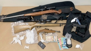 Some of the drugs, weapons and cash seized by police. (Lethbridge police handout)