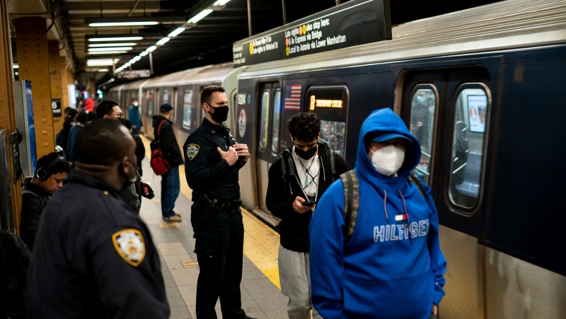 New York City Police Department officers patrol platforms at the 36th Street subway station, April 13, 2022, during the morning commute where a shooting attack occurred the previous day, in New York. (AP Photo/John Minchillo)
