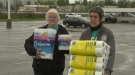 Ellen Faulkner and Angela Johnston bring more donated toilet rolls into a storage container camped out by Parker's Your Independent Grocer. Eric Taschner photo