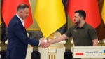 Ukrainian President Volodymyr Zelenskyy, right, and Polish President Andrzej Duda shake hands during a news conference after their meeting in Kyiv, Ukraine, Sunday, May 22, 2022. (AP Photo/Efrem Lukatsky)