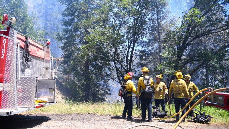 A Cal Fire engine crew readies to help secure a flank of the Golden Fire off of Highway 49 south of Camptonville, Calif. Friday, May 20, 202. (Elias Funez/The Union via AP)