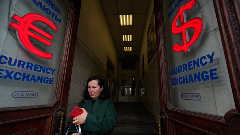 A woman leaves a currency exchange office in St. Petersburg, Russia, Monday, May 23, 2022. (AP Photo)