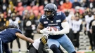 Toronto Argonauts linebacker Henoc Muamba (10) runs with the ball against the Hamilton Tiger-Cats, during first half CFL Eastern Conference final action in Toronto, on Sunday, Dec. 5, 2021. THE CANADIAN PRESS/Christopher Katsarov
