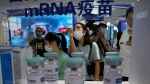 Visitors look at a display by Sinopharm subsidiary CNBG at the China International Fair for Trade in Services (CIFTIS) in Beijing, China, on Sept. 5, 2021. (Ng Han Guan / AP) 