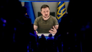 Ukrainian President Volodymyr Zelenskyy displayed on a screen as he addresses the audience from Kyiv on a screen during the World Economic Forum in Davos, Switzerland, on May 23, 2022. (Markus Schreiber / AP) 