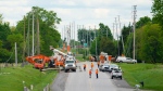 Hydro Crews work to fix broken power poles and restore power in the Ottawa Valley municipality of Mississippi Mills, Ont. on Monday, May 23, 2022. A major storm hit parts of Ontario and Quebec on Saturday, May 21, 2022, leaving extensive damage to infrastructure. THE CANADIAN PRESS/Sean Kilpatrick 