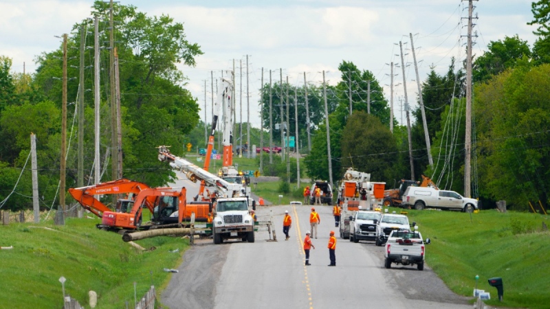 Hydro Crews work to fix broken power poles and restore power in the Ottawa Valley municipality of Mississippi Mills, Ont. on May 23, 2022.  (Sean Kilpatrick / THE CANADIAN PRESS)