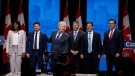 Candidates, left to right, Leslyn Lewis, Roman Baber, Jean Charest, Scott Aitchison, Patrick Brown, and Pierre Poilievre pose on stage following the Conservative Party of Canada English leadership debate in Edmonton, Alta., Wednesday, May 11, 2022.THE CANADIAN PRESS/Jeff McIntosh