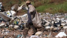 A waste picker rummages through garbage, at a dumping site in Johannesburg, South Africa, Friday, May 20, 2022. (AP Photo/Themba Hadebe)