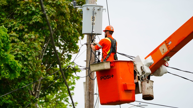 Hydro Crews work to fix broken power poles and restore power in the Ottawa Valley community of Carleton Place, Ontario on Tuesday, May 24, 2022. A major storm hit parts of Ontario and Quebec on Saturday. THE CANADIAN PRESS/Sean Kilpatrick