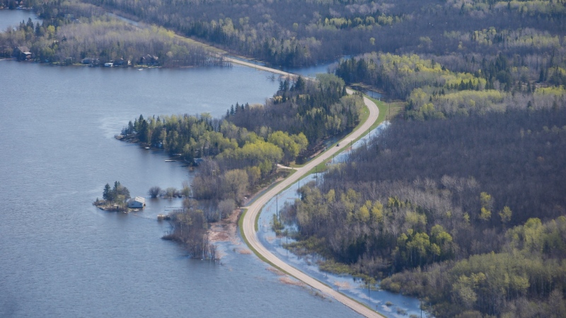 High water levels are washing out highway 307 and leading to several hundred residents being evacuated just north east of Winnipeg, Tuesday, May 24, 2022. Due to high water levels this year, several hundred residents have been evacuated from the area. THE CANADIAN PRESS/John Woods