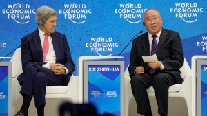 John F. Kerry, Special Presidential Envoy for Climate of the United States, left, listens to Xie Zhenhua, Special Envoy for Climate Change of the People's Republic of China, during the World Economic Forum in Davos, Switzerland, Tuesday, May 24, 2022. (AP Photo/Markus Schreiber)