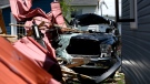 A pickup truck is seen where it was blown off a driveway and destroyed, after the roof of a hardware store lifted off and crashed into neighbouring houses during a major storm, in the community of Hammond in Clarence-Rockland, Ont., on Monday, May 23, 2022. (Justin Tang/THE CANADIAN PRESS)