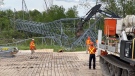 Hydro One crews work to dismantle and reconstruct three nearly 50-meter tall hydro towers that were blown down during Saturday's storm. Ottawa, Ont. May 24, 2022. (Tyler Fleming / CTV News Ottawa)