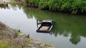 When police arrived, they found a vehicle submerged in more than a metre of water in a channel of the Cowichan River, the RCMP said. (Submitted)