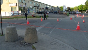 Montreal police officers respond to a shooting in RDP on Tuesday, May 24, 2022. The window of a daycare nearby was hit with bullets. (Cosmo Santamaria/CTV News)