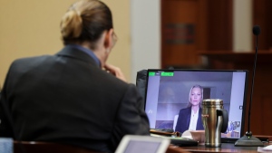 Kate Moss testifies via video link as Depp looks on at the Fairfax County Circuit Courthouse, on May 25, 2022. (Evelyn Hockstein / Pool photo via AP) 
