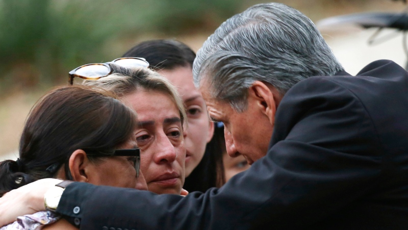 The archbishop of San Antonio, Gustavo Garcia-Siller, comforts families outside the Civic Center following a deadly school shooting at Robb Elementary School in Uvalde, Texas, Tuesday, May 24, 2022. (AP Photo/Dario Lopez-Mills)