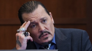 Actor Johnny Depp testifies in the courtroom in the Fairfax County Circuit Courthouse in Fairfax, Va., Wednesday, May 25, 2022. Depp sued his ex-wife Amber Heard for libel in Fairfax County Circuit Court after she wrote an op-ed piece in The Washington Post in 2018 referring to herself as a "public figure representing domestic abuse." (Evelyn Hockstein/Pool photo via AP)