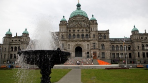Orange shirts, shoes, flowers and messages are on display on the steps outside the legislature in Victoria, B.C., on Saturday, June 12, 2021. THE CANADIAN PRESS/Chad Hipolito 