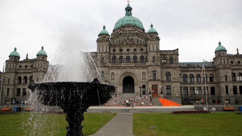Orange shirts, shoes, flowers and messages are on display on the steps outside the legislature in Victoria, B.C., on Saturday, June 12, 2021. THE CANADIAN PRESS/Chad Hipolito 