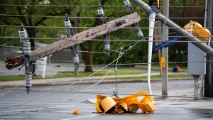 A traffic light and segment of a utility pole are seen in the intersection of Viewmount Drive and Merivale Road after a major storm took down power lines and utility poles, blocking in multiple vehicles, on Merivale Road in Ottawa, on Saturday, May 21, 2022. (Justin Tang/THE CANADIAN PRESS) 