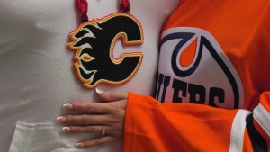 A proposal by Flames fan Payden Partaker at Game 4 of the Battle of Alberta received a resounding "yes" from the Oilers-loving Tessa Monais. May 25, 2022. (CTV News Edmonton)