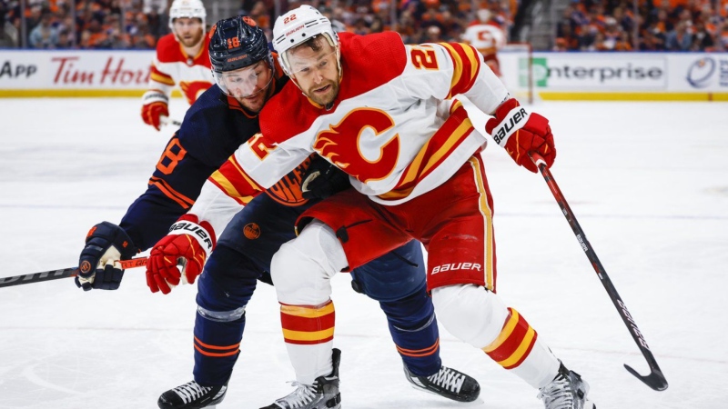 Calgary Flames forward Trevor Lewis, right, holds back Edmonton Oilers winger Zach Hyman during third period NHL second-round playoff hockey action in Edmonton, Tuesday, May 24, 2022. (THE CANADIAN PRESS/Jeff McIntosh)