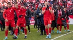 Members of Canada's national soccer team celebrate after clinching a berth in CONCACAF World Cup Qualifier soccer action against Jamaica in Toronto on Sunday March 27, 2022 THE CANADIAN PRESS/Frank Gunn