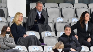 Chelsea soccer club owner Roman Abramovich, top, uses a blanket to shelter from the cold, during the UEFA Women's Champions League final soccer match between Chelsea FC and FC Barcelona in Gothenburg, Sweden, on May 16, 2021. (Martin Meissner / AP) 