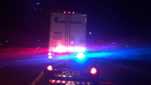 Police stop a transport truck on Highway 400 near CR 88 in Bradford, Ont. (OPP_CR/Twitter)