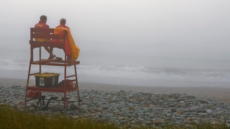 Members of the Nova Scotia Lifeguard Service guard Lawrencetown Beach near Halifax in heavy fog Saturday, Sept. 8, 2007. (CP PHOTO/Andrew Vaughan) 