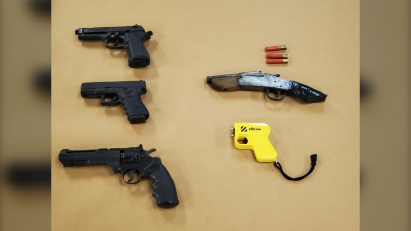 Weapons seized from London police during the execution of a search warrant on May 24, 2022, including a sawed-off shotgun, a conductive energy weapon and three replica firearms. (Source: London Police Service)
