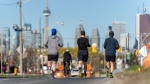 FILE - A group of runners run along Lake Shore Blvd. East as road closures come into effect for the return of the ActiveTO program in Toronto on Saturday, May 1, 2021.THE CANADIAN PRESS/Yader Guzman 