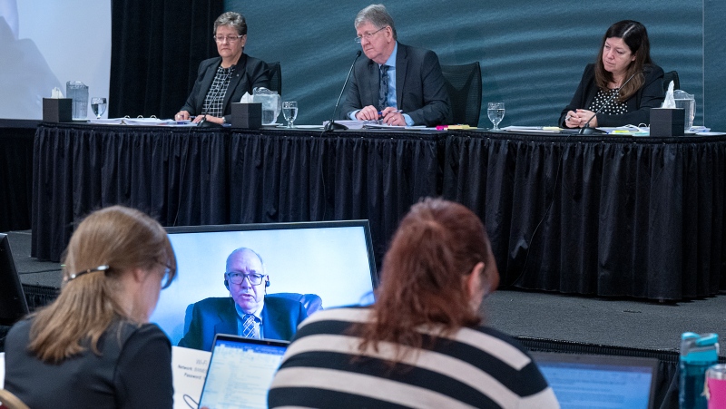 Commissioners Leanne Fitch, Michael MacDonald, chair, and Kim Stanton, left to right, watch as Al Carroll, a retired RCMP staff sergeant and former district commander for Colchester County, appears by video at the Mass Casualty Commission inquiry into the mass murders in rural Nova Scotia on April 18/19, 2020, in Truro, N.S. on Thursday, May 26, 2022. THE CANADIAN PRESS/Andrew Vaughan 