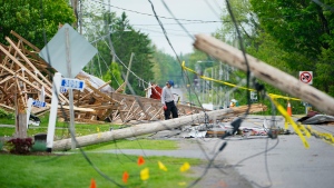 A resident of Hammond, Ont., cleans up wreckage on Thursday, May 26, 2022. A major storm hit parts of Ontario and Quebec on Saturday, May 21, 2022, killing 11 people and leaving extensive damage to infrastructure, homes, and business. (Sean Kilpatrick/THE CANADIAN PRESS)