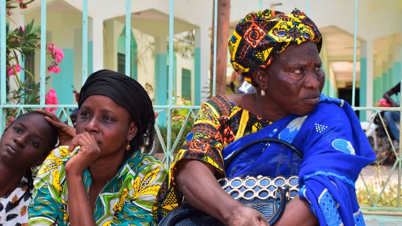 Relatives sit outside the Abdoul Aziz Sy Dabakh Hospital in Tivaouane, Senegal, a town 90 kms ( 60 miles) east of Dakar Thursday, May 26, 2022.  (AP Photo/Cheik Sy)