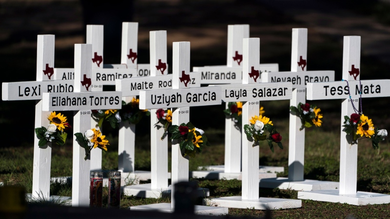 Crosses with the names of Tuesday's shooting victims are placed outside Robb Elementary School in Uvalde, Texas, Thursday, May 26, 2022. (AP Photo/Jae C. Hong)