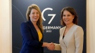 Annalena Baerbock, foreign minister of Germany, right, welcomes Melanie Joly, foreign minister of Canada, at the summit of foreign ministers of the G7 Group of leading democratic economic powers at the Weissenhaus resort in Weissenhaeuser Strand, Germany, May 13, 2022. (Marcus Brandt/Pool via AP)