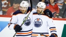 Edmonton Oilers defenceman Evan Bouchard, right,celebrates his goal with teammate centre Leon Draisaitl during second period NHL second-round playoff hockey action against the Calgary Flames in Calgary, Thursday, May 26, 2022. (THE CANADIAN PRESS/Jeff McIntosh)