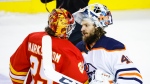 Edmonton Oilers goalie Mike Smith, right, and Calgary Flames goalie Jacob Markstrom shakes hands following overtime NHL second-round playoff hockey action in Calgary, Thursday, May 26, 2022 (The Canadian Press/Jeff McIntosh).