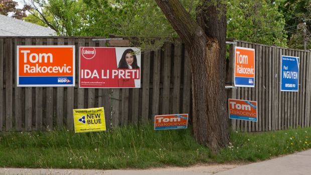 Signs for candidates for the 2022 Ontario general election, adorn a fence in Toronto on Wednesday, May 25, 2022. THE CANADIAN PRESS/Chris Young 