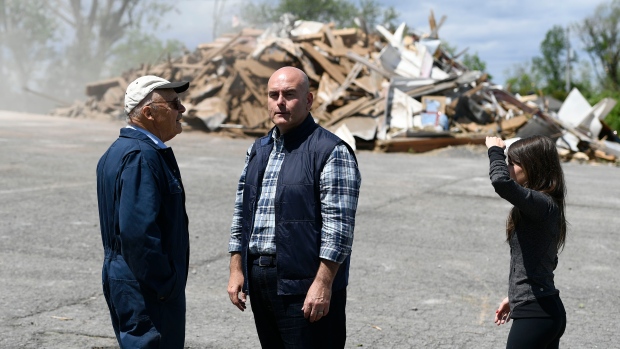 Ontario Liberal Party Leader Steven Del Duca, centre, speaks with resident and former MP Don Boudria as he visits Paroisse Saint-Hugues, which lost its steeple during a major storm with Liberal candidate for Glengarry–Prescott–Russell Amanda Simard, in Sarsfield, Ont., on Monday, May 23, 2022. THE CANADIAN PRESS/Justin Tang 