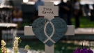 Messages are written on a cross honoring Irma Garcia, a teacher who was killed in this week's elementary school shooting, in Uvalde, Texas, Thursday, May 26, 2022. (AP Photo/Jae C. Hong)