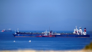 The Pegas tanker, that has recently changed its name to Lana, foreground, is surrounded by other vessels off the port of Karystos on the Aegean Sea island of Evia, Greece, Friday, May 27, 2022. The crude oil cargo of the Iranian-flagged tanker that was stopped in Greek waters last month has been seized and is being transferred to another vessel following a request from the U.S., a Greek official said Thursday. (AP Photo/Thanassis Stavrakis)