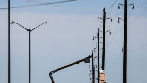 A utility worker works from a bucket lift along Hawthorne Road after Saturday’s major storm caused significant damage to the city’s power distribution network, in Ottawa, on Tuesday, May 24, 2022. (Justin Tang/THE CANADIAN PRESS)
