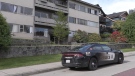 An apartment building was behind police tape in Vancouver on May 27, 2022.